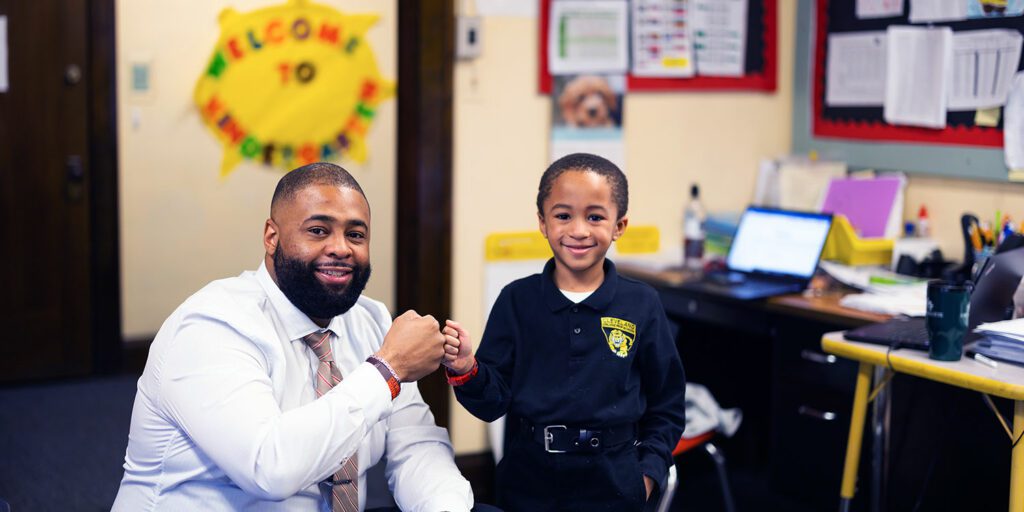 Smiling school staff member and student.